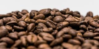 A pile of mixed coffee beans against a white background