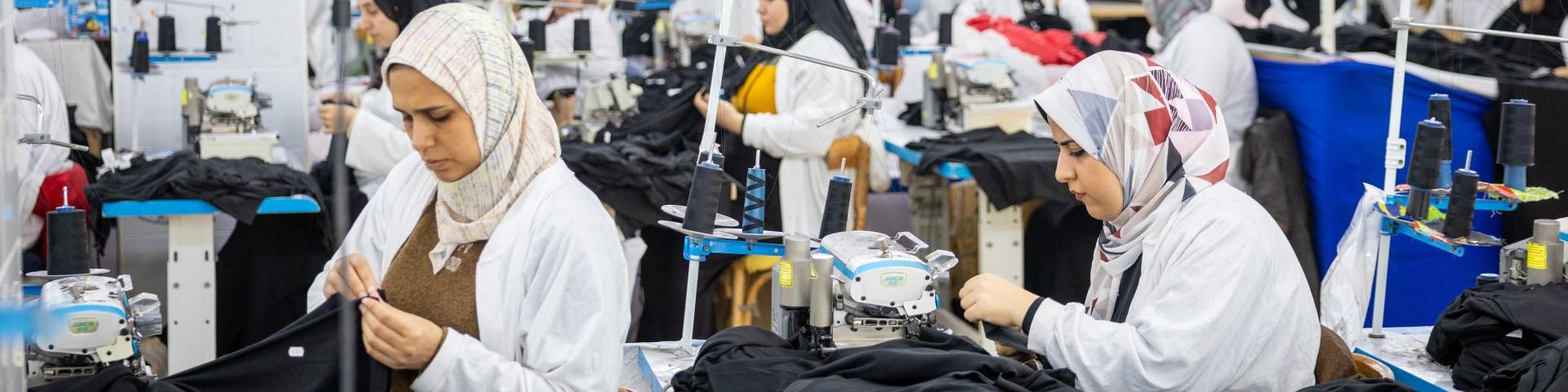 Women wearing headscarves working in an apparel factory