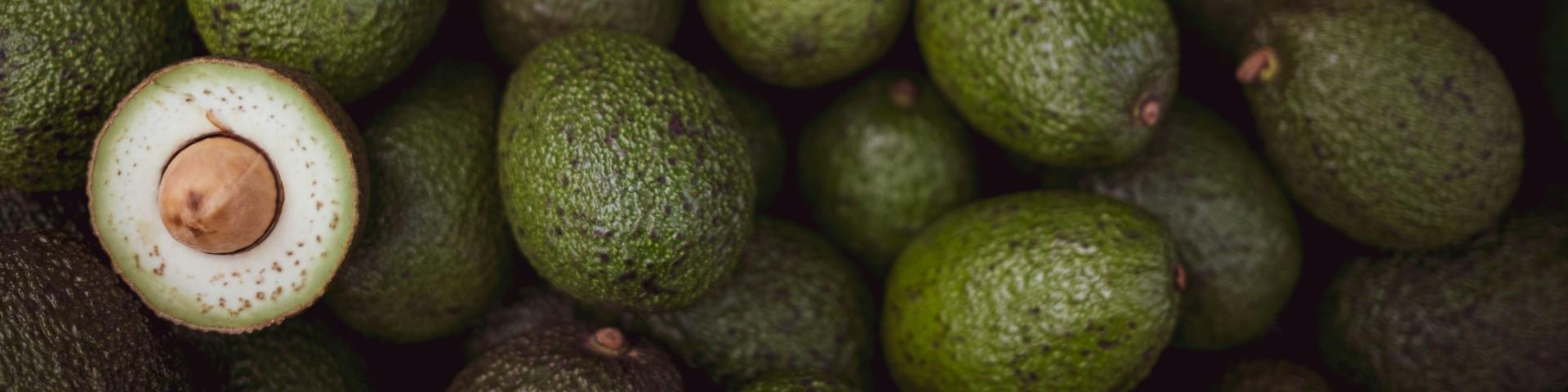 A bunch of fresh green avocados