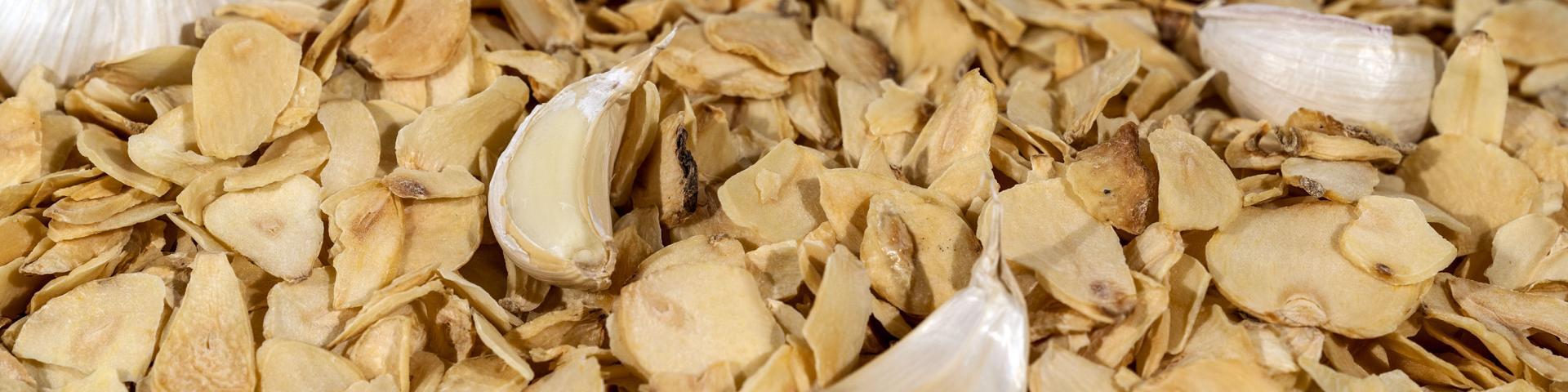 Close-up of dried garlic slices mixed with garlic cloves