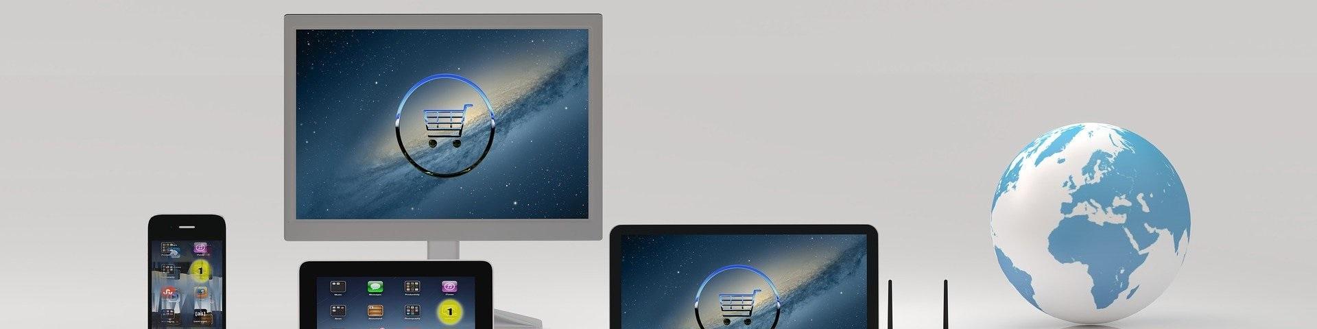 Digital design showing a computer screen, tablet and telephone, with a globe on the right-hand side