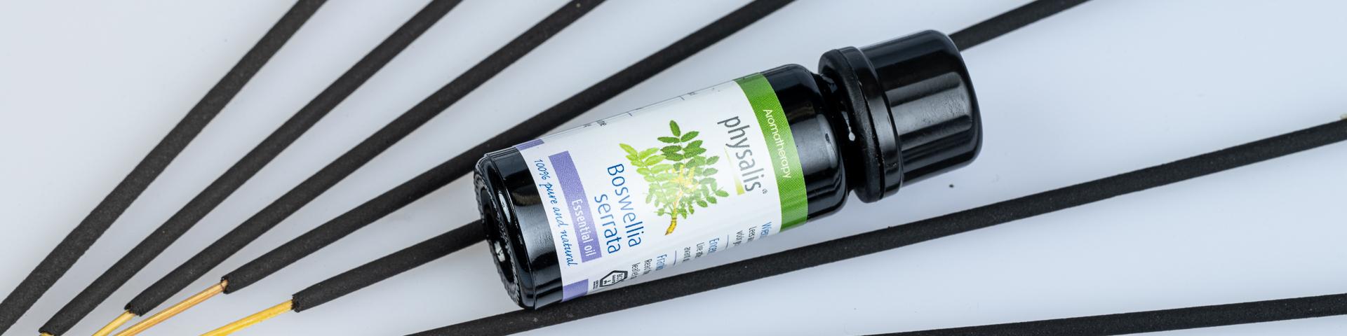 Frankincense sticks with a bottle of Boswellia serrata essential oil placed between them