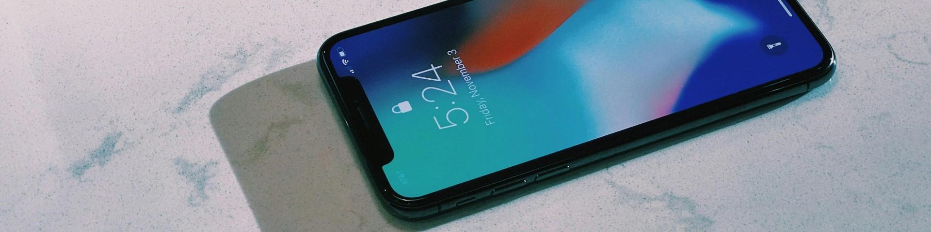 Phone on marble counter with visible lockscreen