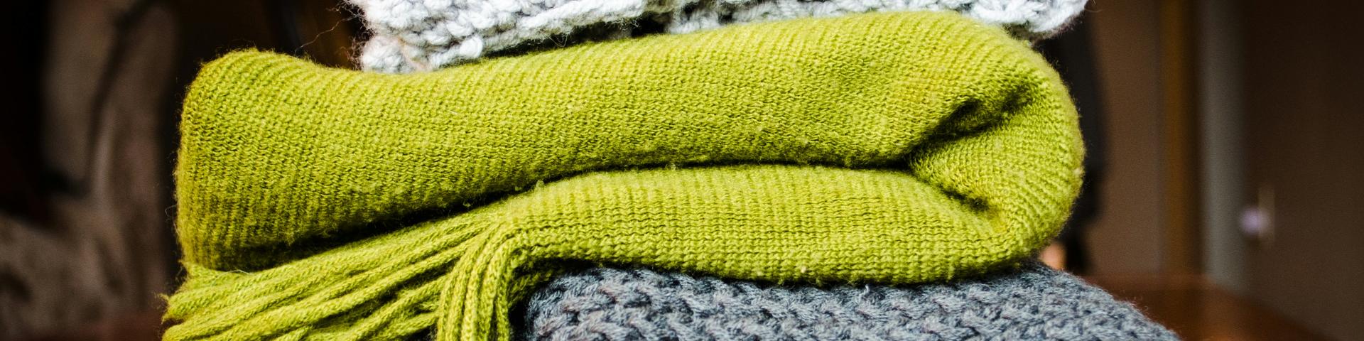 Three coloured scarves stacked on top of one another