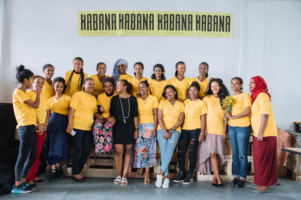 Kabana team standing together in yellow shirts