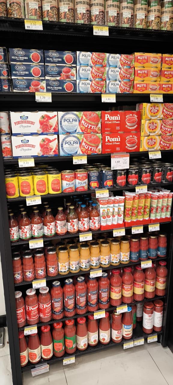 Typical Italian supermarket shelf with processed tomato products