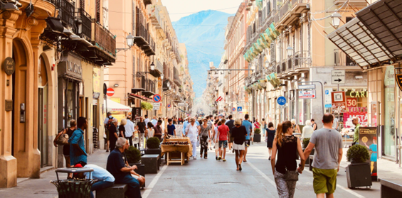 Sunny shopping street filled with people