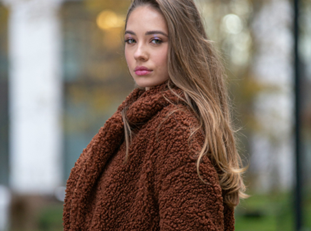 Woman wearing dark brown teddy fleece coat