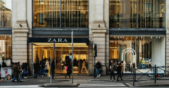 People walking in front of the entrance to an apparel store
