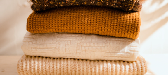 A stack of knitwear in natural colors