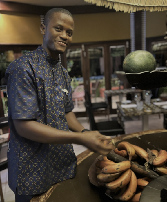 Photo of a smiling man with bananas