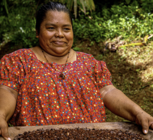 Photo of a woman holding a tray of beans