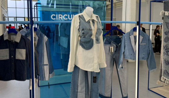 Mannequin wearing a denim vest in a clothing store
