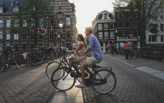 Two people cycling in a Dutch street
