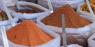 Containers filled with various dried spices and herbs