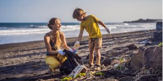 People picking up litter from a beach