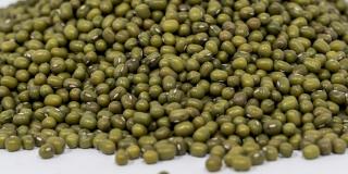 A pile of dried mung beans against a white background