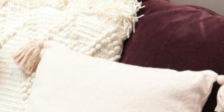 Close-up of five beige, white and black pillows