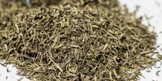 Dried thyme leaves against a white background