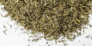 Dried thyme leaves against a white background