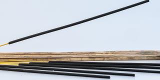 Frankincense sticks placed beside a bottle of Boswellia Serrata essential oil