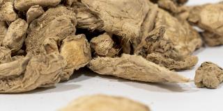 Pieces of dried ginger against a white background