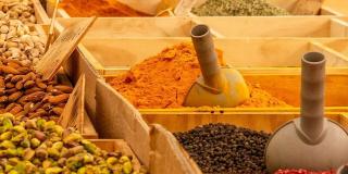 Various kinds of fresh nuts and spices laid out in wooden boxes